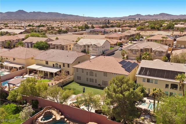 aerial view of residential area featuring a mountain backdrop
