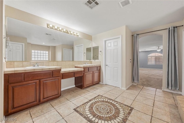358 Whispering Tree Ave, Las Vegas, NV 89183 - full bathroom featuring tile patterned floors, vanity, baseboards, ceiling fan, and tasteful backsplash