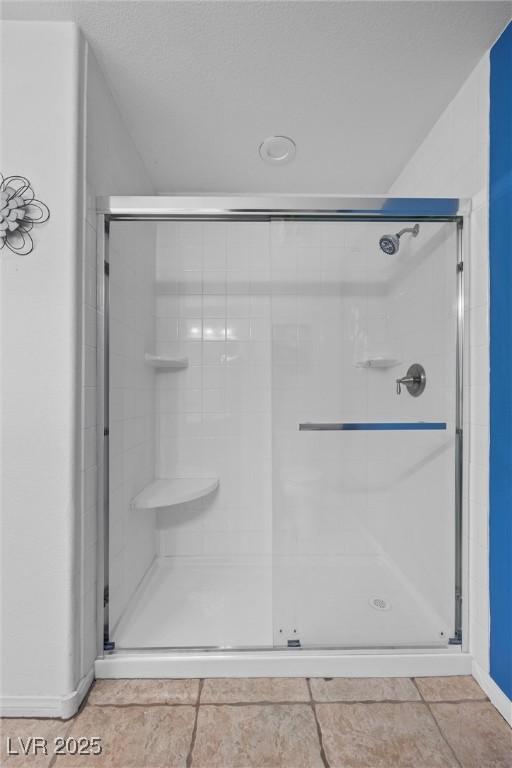 358 Whispering Tree Ave, Las Vegas, NV 89183 - full bathroom with a shower stall, baseboards, and tile patterned floors
