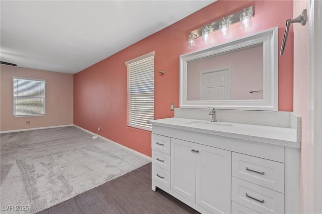 358 Whispering Tree Ave, Las Vegas, NV 89183 - bathroom with vanity, baseboards, and wood finished floors