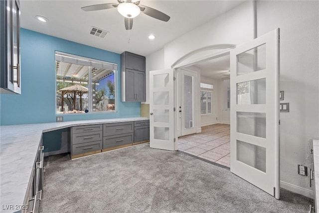 unfurnished office featuring french doors, light carpet, a ceiling fan, and recessed lighting