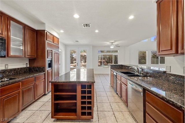 kitchen with dishwasher, a sink, paneled built in refrigerator, french doors, and recessed lighting