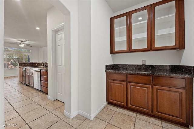 bar area featuring stainless steel dishwasher, light tile patterned floors, arched walkways, baseboards, and recessed lighting