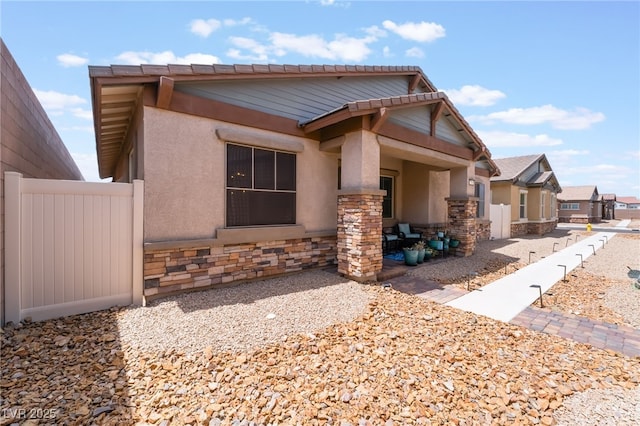 778 Dainty Daffodil St, Henderson, NV 89011 - view of front of property featuring stucco siding, stone siding, and fence