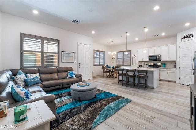778 Dainty Daffodil St, Henderson, NV 89011 - living area with light wood-type flooring, recessed lighting, and a chandelier