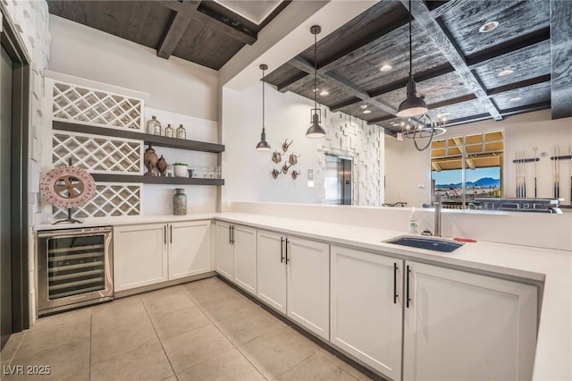 778 Dainty Daffodil St, Henderson, NV 89011 - indoor bar featuring wine cooler, coffered ceiling, a chandelier, light tile patterned floors, and pendant lighting