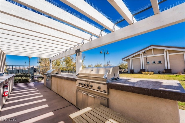 778 Dainty Daffodil St, Henderson, NV 89011 - view of patio / terrace with area for grilling, exterior kitchen, a pergola, and fence