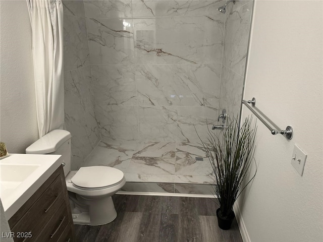 7885 W Flamingo Rd Unit 2019, Las Vegas, NV 89147 - bathroom with a shower stall, toilet, wood finished floors, and vanity