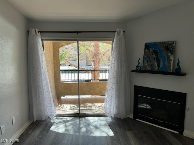 7885 W Flamingo Rd Unit 2019, Las Vegas, NV 89147 - entryway featuring wood finished floors, a glass covered fireplace, and baseboards