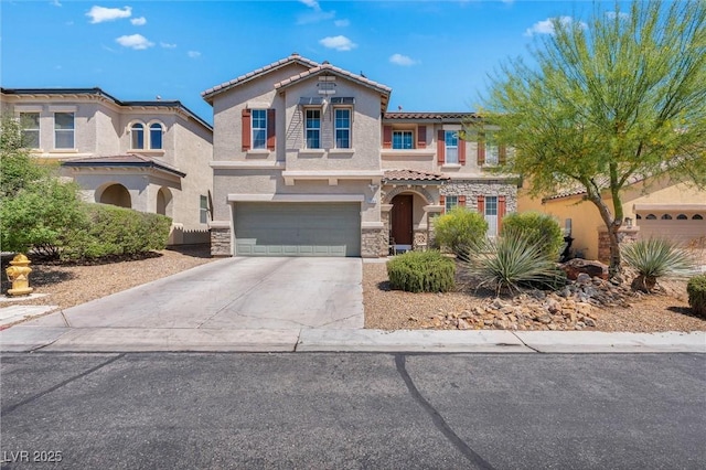 mediterranean / spanish home with stucco siding, a tiled roof, stone siding, an attached garage, and concrete driveway