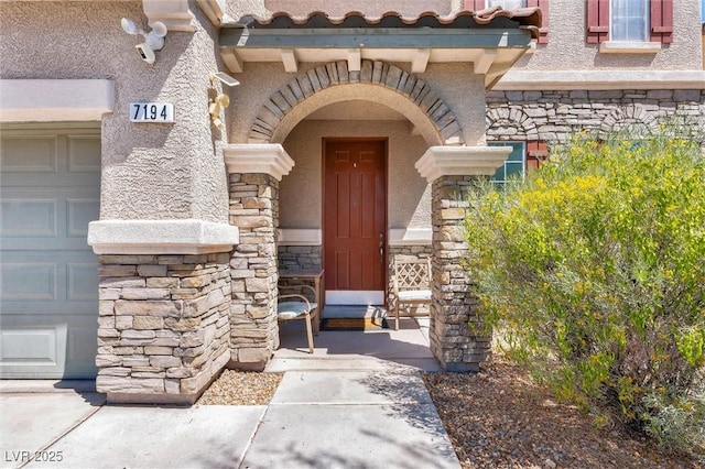entrance to property featuring stone siding and stucco siding