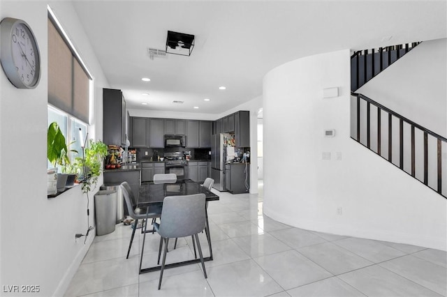 dining room featuring baseboards, stairs, recessed lighting, and light tile patterned flooring