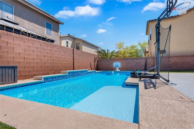 view of swimming pool featuring a fenced backyard and a patio area