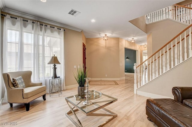 living area with baseboards, stairs, wood finished floors, and recessed lighting