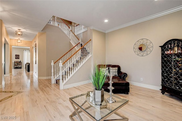 sitting room featuring stairway, baseboards, wood finished floors, ornamental molding, and recessed lighting