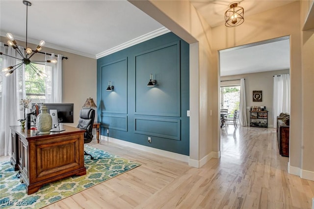 office space with a chandelier, wood finished floors, crown molding, and baseboards