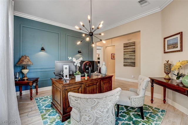 office featuring a chandelier, ornamental molding, light wood-type flooring, and baseboards
