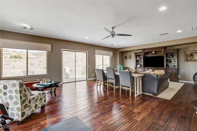 living area featuring a ceiling fan, dark wood finished floors, baseboards, and recessed lighting