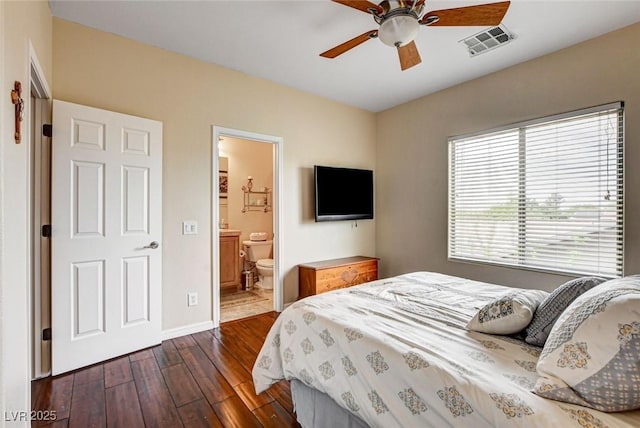 bedroom featuring dark wood-type flooring, baseboards, ceiling fan, and connected bathroom