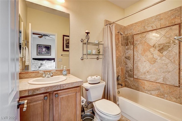 bathroom featuring vanity, toilet, shower / bathtub combination with curtain, and ceiling fan