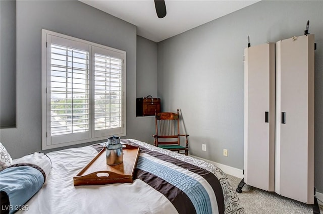 bedroom featuring multiple windows, carpet, baseboards, and ceiling fan
