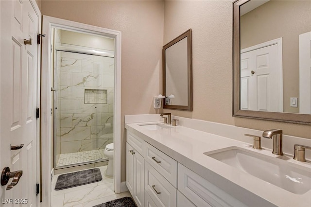 full bath with marble finish floors, toilet, a shower stall, and double vanity