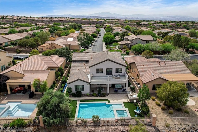 aerial perspective of suburban area with a pool area and mountains