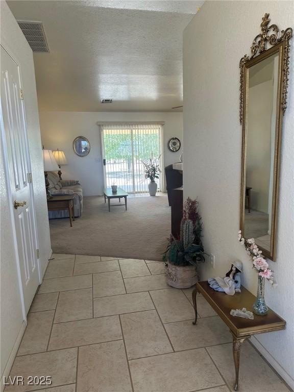 1461 E Elderberry St, Pahrump, NV 89048 - corridor with light carpet and light tile patterned flooring