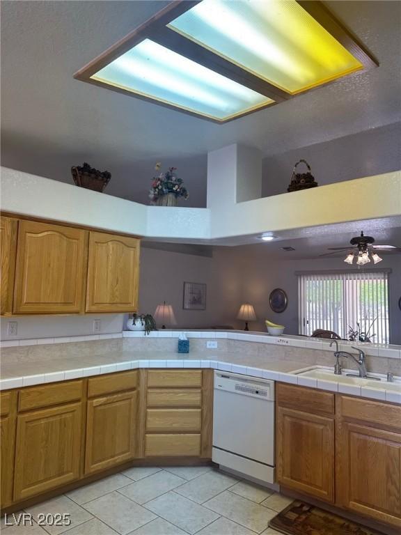 1461 E Elderberry St, Pahrump, NV 89048 - kitchen featuring dishwasher, light tile patterned flooring, high vaulted ceiling, and a ceiling fan