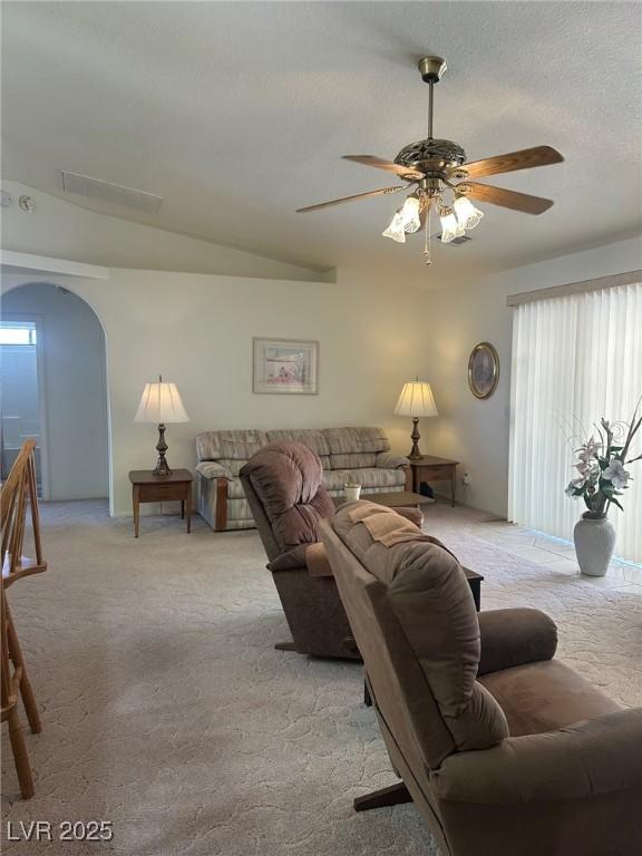 1461 E Elderberry St, Pahrump, NV 89048 - living room featuring light colored carpet, plenty of natural light, a ceiling fan, and arched walkways