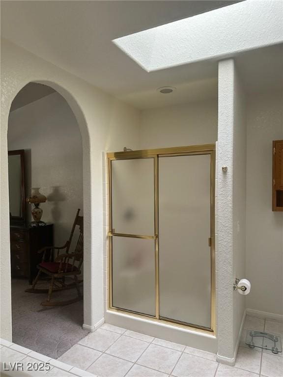 1461 E Elderberry St, Pahrump, NV 89048 - bathroom with tile patterned flooring, a shower stall, and a skylight