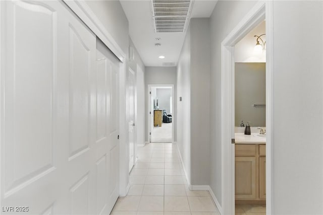2612 Dearport Ct, Henderson, NV 89052 - hallway featuring light tile patterned flooring, baseboards, and a sink