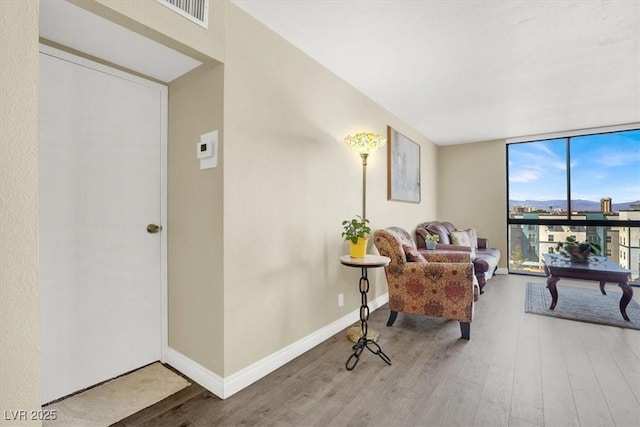 3930 University Center Dr Unit 603, Las Vegas, NV 89119 - sitting room featuring expansive windows, wood finished floors, and baseboards