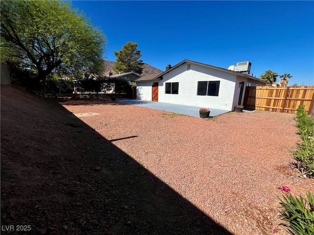 407 Tiger Lily Way, Henderson, NV 89015 - back of property with stucco siding, a patio area, and an attached garage