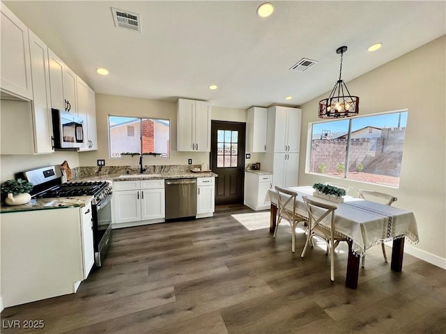 407 Tiger Lily Way, Henderson, NV 89015 - kitchen with appliances with stainless steel finishes, a chandelier, white cabinets, a sink, and recessed lighting