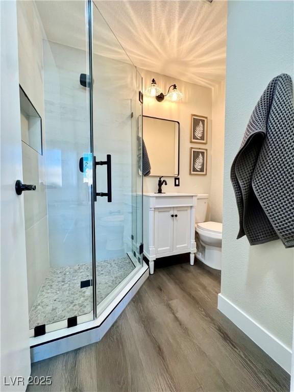 407 Tiger Lily Way, Henderson, NV 89015 - full bath featuring wood finished floors, vanity, toilet, a shower stall, and baseboards
