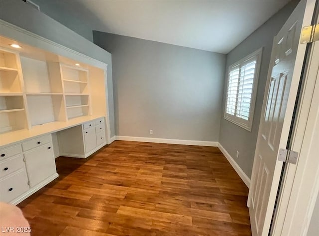 5165 Briar Meadow Way, Las Vegas, NV 89118 - unfurnished office featuring built in desk, dark wood-type flooring, and baseboards