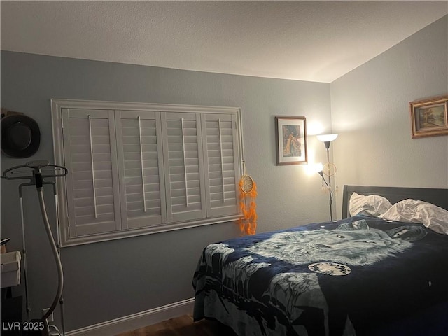 5165 Briar Meadow Way, Las Vegas, NV 89118 - bedroom featuring dark wood-style flooring, vaulted ceiling, and baseboards