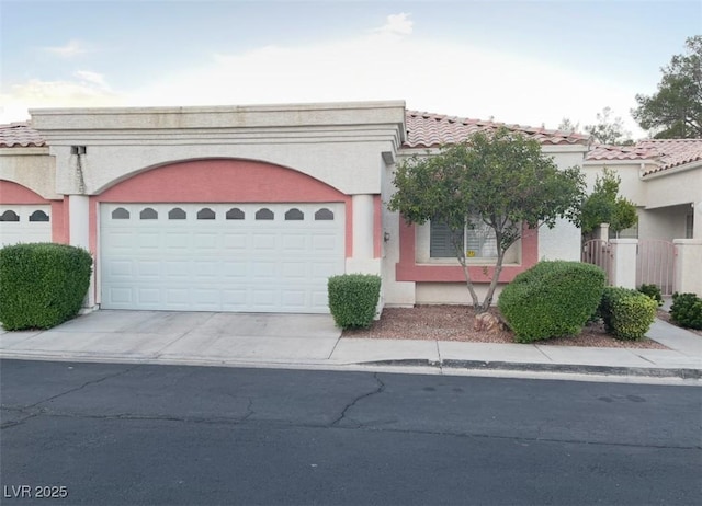 5165 Briar Meadow Way, Las Vegas, NV 89118 - view of front of home featuring concrete driveway, an attached garage, stucco siding, and a tiled roof
