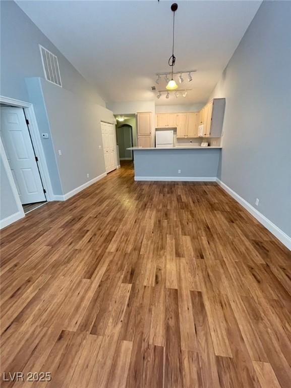 5165 Briar Meadow Way, Las Vegas, NV 89118 - unfurnished living room featuring dark wood finished floors, baseboards, and rail lighting