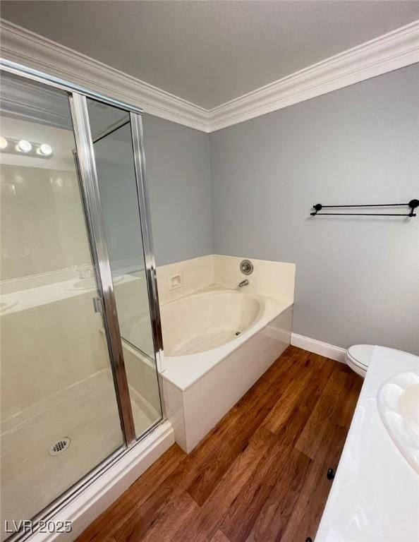 5165 Briar Meadow Way, Las Vegas, NV 89118 - bathroom with ornamental molding, a shower stall, wood finished floors, a bath, and baseboards