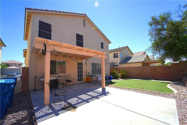 6002 Stone Hollow Ave, Las Vegas, NV 89156 - rear view of house with stucco siding, a pergola, and a patio