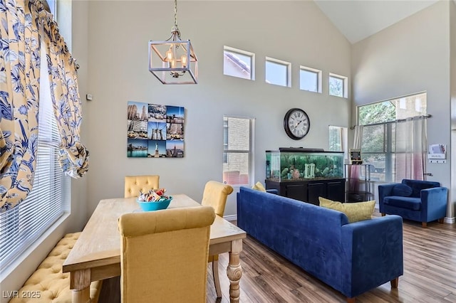 5502 Cinnamon Ave, Las Vegas, NV 89122 - dining room featuring high vaulted ceiling, a chandelier, and wood finished floors