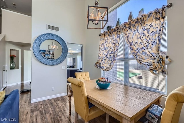 5502 Cinnamon Ave, Las Vegas, NV 89122 - dining room with a chandelier, wood finished floors, baseboards, healthy amount of natural light, and a high ceiling