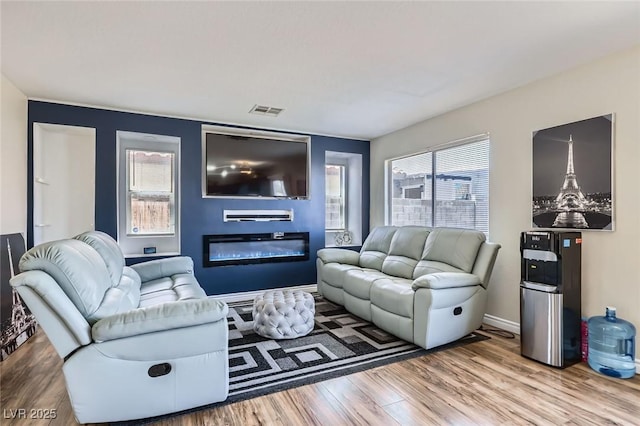 5502 Cinnamon Ave, Las Vegas, NV 89122 - living area with wood finished floors and a glass covered fireplace