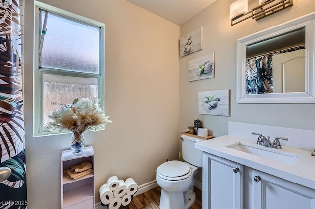 5502 Cinnamon Ave, Las Vegas, NV 89122 - full bathroom with vanity, toilet, wood finished floors, and baseboards