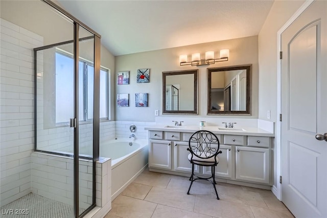 5502 Cinnamon Ave, Las Vegas, NV 89122 - bathroom featuring double vanity, a stall shower, a bath, and tile patterned flooring