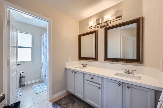 5502 Cinnamon Ave, Las Vegas, NV 89122 - full bath featuring double vanity, tile patterned floors, baseboards, and a shower with shower curtain