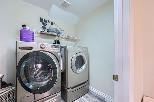 5502 Cinnamon Ave, Las Vegas, NV 89122 - washroom featuring washing machine and clothes dryer, wood finished floors, and baseboards