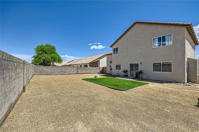 5502 Cinnamon Ave, Las Vegas, NV 89122 - rear view of property with a fenced backyard, stucco siding, and a patio area